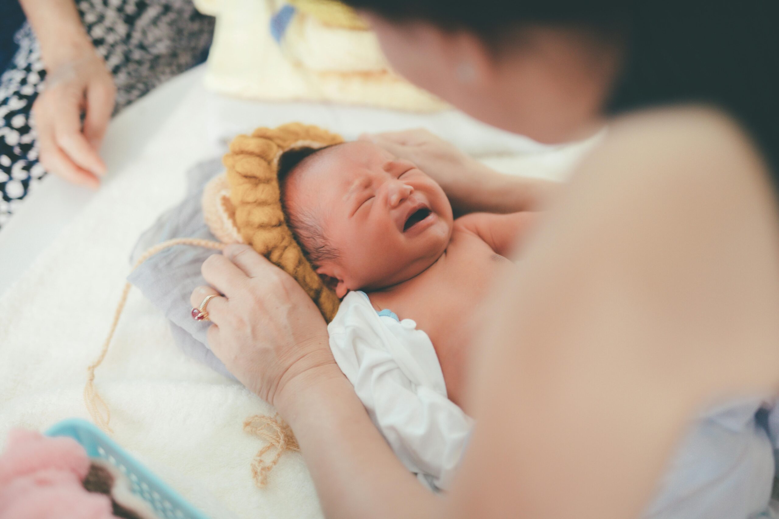 Newborn baby taking first breath after birth in hospital